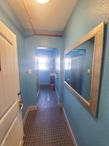 a hallway with a bathroom with a toilet and a mirror at The Chadwick in San Diego