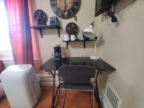 a desk with a chair and a clock on the wall at The Chadwick in San Diego