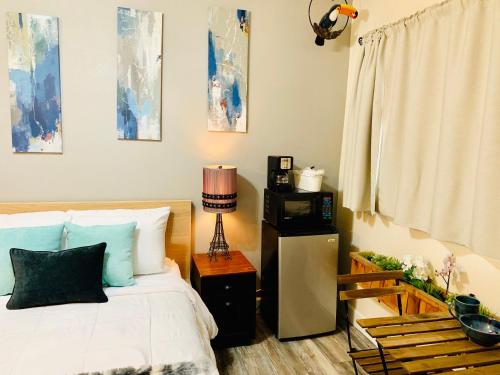 a bedroom with a bed and a microwave and a lamp at The Chadwick in San Diego