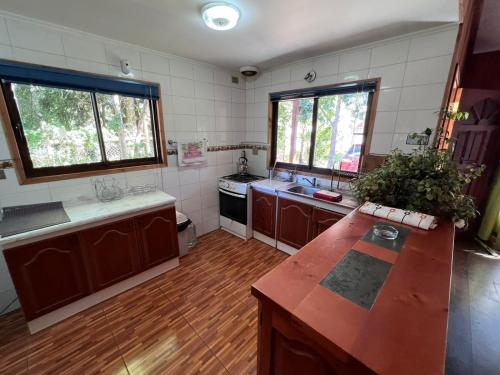 a kitchen with a wooden counter top in a room at Cabañas Welcome Pucón. in Pucón