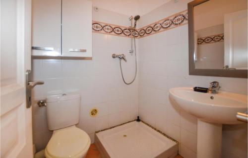 a bathroom with a toilet and a sink at Lovely Apartment In Costa With Outdoor Swimming Pool in Costa