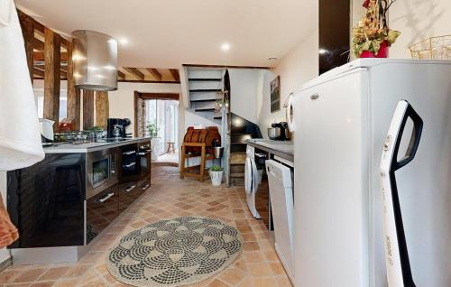 a kitchen with a refrigerator and a counter top at Amazing Home In Neuilly Le Vendin in Neuilly-le-Vendin