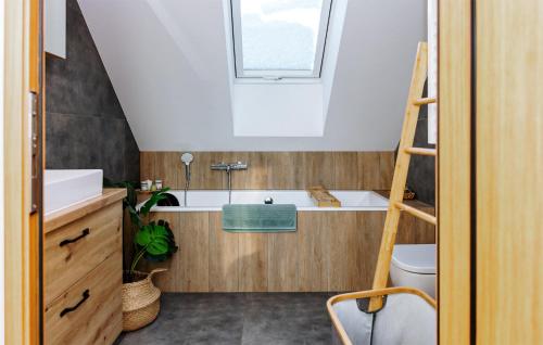 a bathroom with a sink and a bath tub at Beautiful Home In Ryn With Sauna in Ryn
