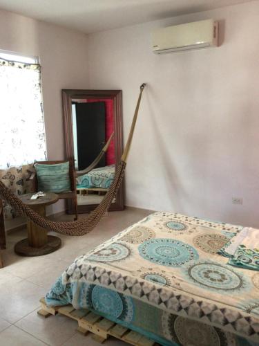a bedroom with a hammock and a mirror at Mar y Luna in Mérida