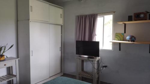 a living room with a television and a window at Cultura Serrana in La Paz