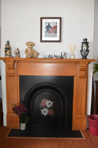 a fireplace with teddy bears on top of it at 74 on Lockhart in Oturehua