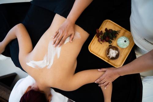 a woman getting a massage from a therapist at Modala Beach Resort in Panglao