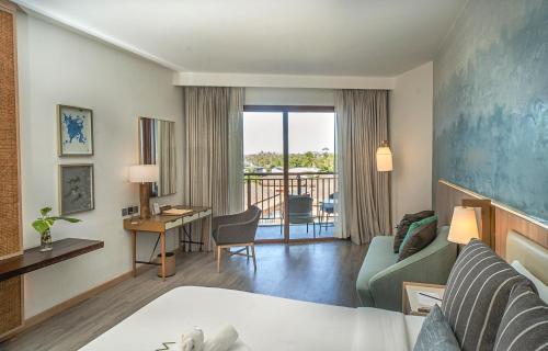 邦勞的住宿－Modala Beach Resort，配有一张床和一张书桌的酒店客房