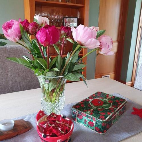 a vase of pink flowers and a box on a table at 74 on Lockhart in Oturehua
