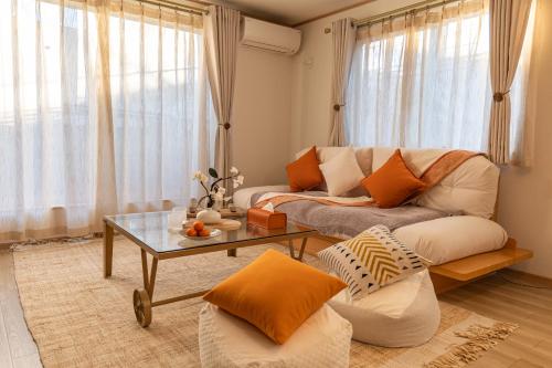 a living room with a couch and a table at 桜の川9 池袋一戸建 2-12人丨Ikebukuro Villa 2-12 people in Tokyo