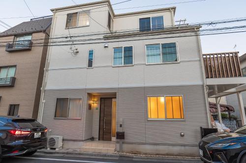 a house with a car parked in front of it at 桜の川9 池袋一戸建 2-12人丨Ikebukuro Villa 2-12 people in Tokyo