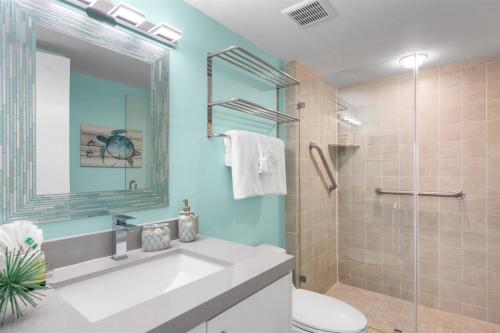 a bathroom with a sink and a toilet and a shower at 1206 Ocean Pointe in Tavernier