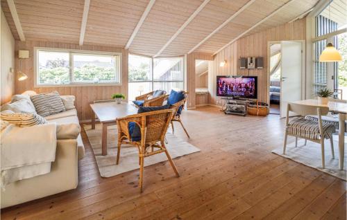 a living room with a couch and a table at Three-Bedroom Holiday Home In Rodby in Rødby