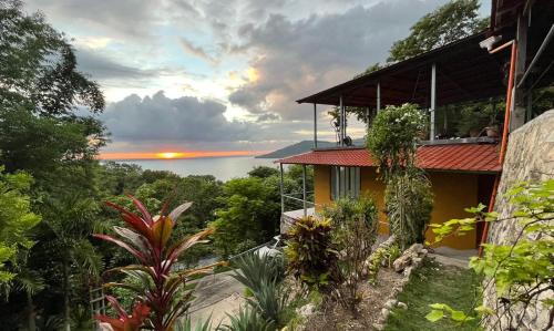 a house with a balcony with a view of the ocean at Casa Alemán in Flores