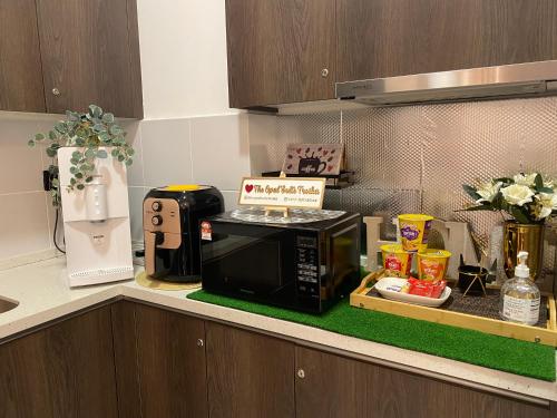 a kitchen counter with a microwave on a counter top at The Opal Suite Troika Kota Bharu 1 Bedroom in Kota Bharu