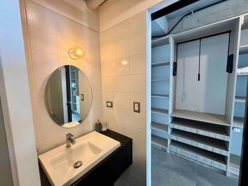 a bathroom with a sink and a mirror at Modern Apartment near Cayala in Guatemala