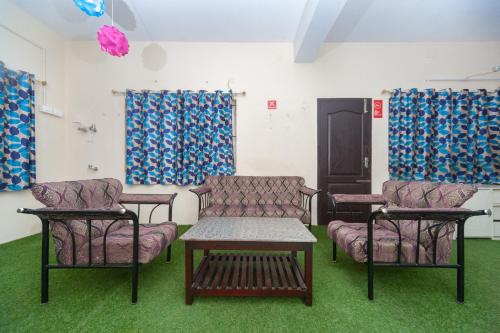 a room with three chairs and a table and a couch at OYO B Square Homes in Singānallūr
