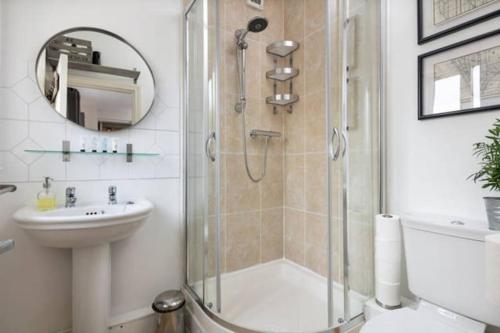 a bathroom with a shower and a toilet and a sink at Large 2 Bedroom City Centre Apartment + Parking in Preston