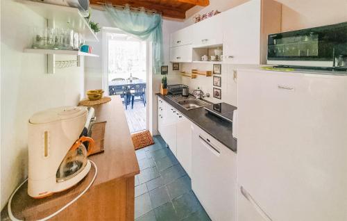 a kitchen with a white refrigerator and a sink at 5 Bedroom Cozy Home In Rowy in Rowy