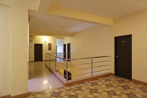 an empty hallway with a staircase and a door at Stellar Resort in Bhubaneshwar