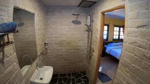 a bathroom with a shower and a sink and a bed at Sapparot Bar & Bungalows in Ko Chang