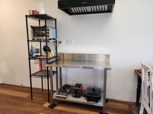 a kitchen with a counter and a shelf with microwaves at Waterfront Abode - 2 bedrooms in Hobart
