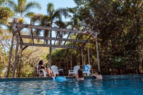 a group of people sitting in a swimming pool at Litchfield Tourist Park in Batchelor