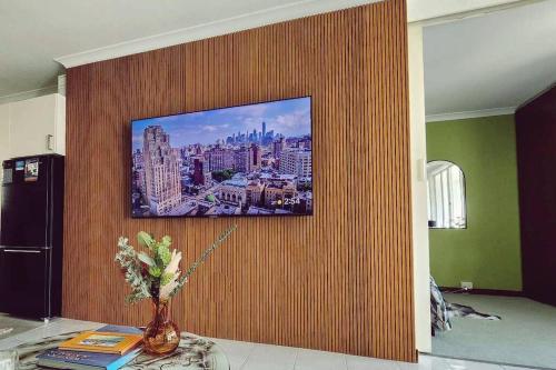 a television hanging on a wall in a living room at Riversong Perth in Perth