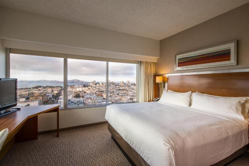 a hotel room with a bed and a large window at Holiday Inn San Francisco - Golden Gateway, an IHG Hotel in San Francisco