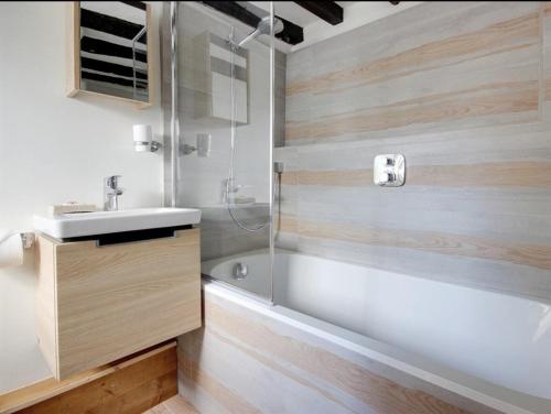 a bathroom with a tub and a sink and a shower at Eglantine in Crondall