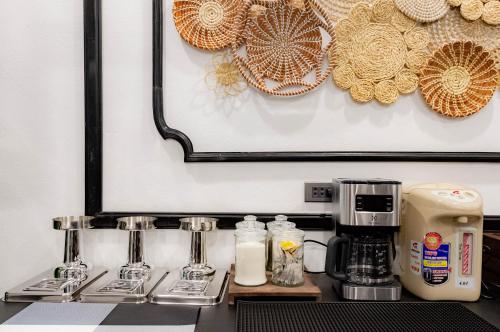 a kitchen counter with a coffee maker and a coffee pot at Cozy An Boutique Hotel Luangprabang in Luang Prabang