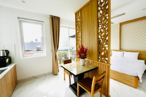 a hotel room with a bed and a table and a bedroom at Le's Apartment & Coffee in Danang