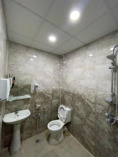 a bathroom with a toilet and a sink at Rahat Hotel in Ganja