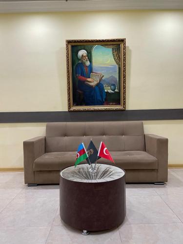 a living room with a couch and a table at Rahat Hotel in Ganja