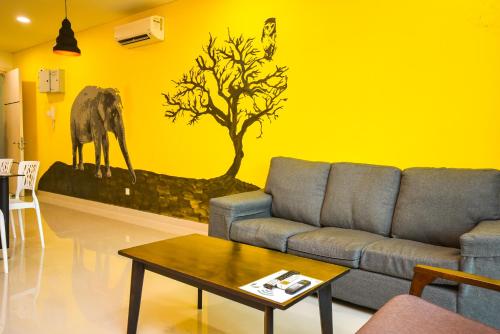 a living room with a couch and an elephant painted on the wall at 1Medini Theme Suite by Nest Home【LEGOLAND】 in Nusajaya