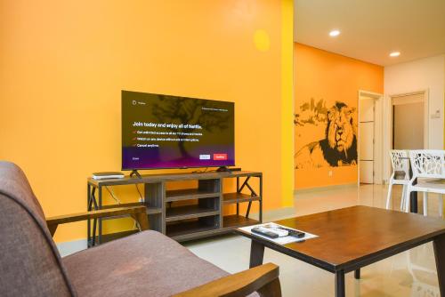 a living room with a tv and a table at 1Medini Theme Suite by Nest Home【LEGOLAND】 in Nusajaya