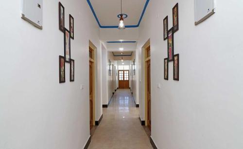 a hallway with white walls and a blue ceiling at OYO Flagship Hotel Ratnodaya in Almora