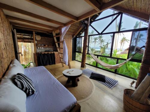 a living room with a couch and a hammock at Tarzan's House in General Luna