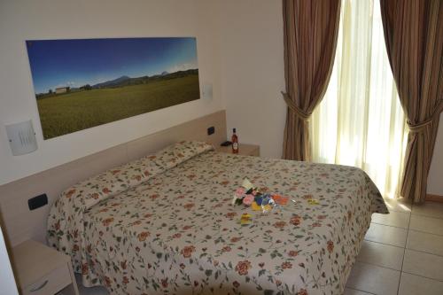 a bedroom with a bed with flowers on it at Locanda Le Palafitte in Bardolino