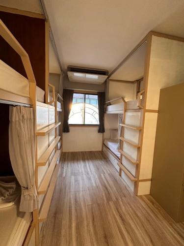a small room with bunk beds and a window at Terminal58hostel@town in Ban Lo Long