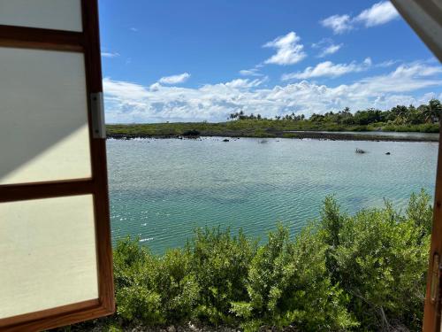 a view of a lake from a window at Rangiroa Bliss in Tiputa