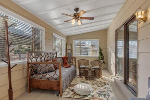 a bedroom with a bed and a ceiling fan at ᨒFIREHAUSᨒHotTubᨒCinemaᨒBBQᨒBadmintonᨒGames in Arvada