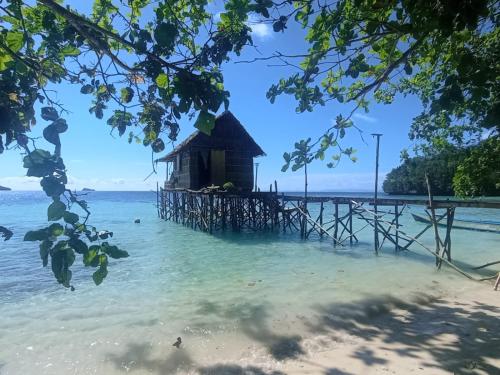a house on a pier in the water at Efenli Arnes homestay in Yennanas Besir
