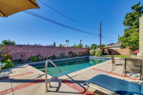 a swimming pool with chairs and an umbrella at Luxury Oasis Home w/Pool Near CSUN-6 Guests in North Hills