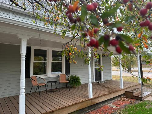a porch of a house with two chairs and a table at Crabapple Cottage in Hesston