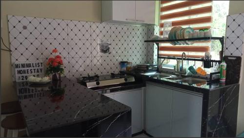 uma cozinha com um fogão e uma bancada em Minimalist Homestay D Pokok Sena em Pokok Sena