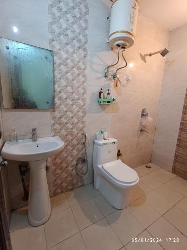 a bathroom with a toilet and a sink at Hobbit in Gurgaon