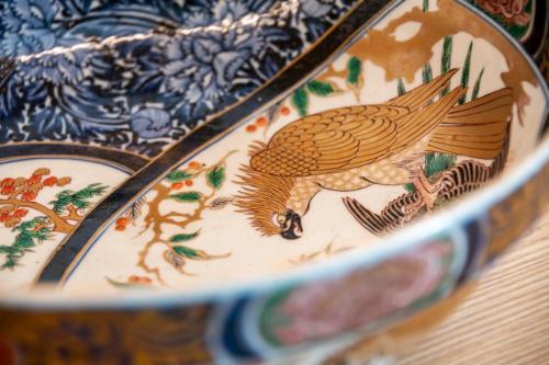 a close up of a plate with a bird on it at Kagetsu Taisyokan in Takeo