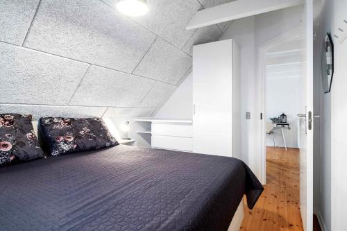 a bedroom with a bed in a room at Charming House By The Baltic Sea in Bøtø By