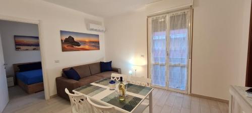 a living room with a table and a couch at Aedes Residenza Lido - 80 mt dalla spiaggia - self check-in in Alghero
